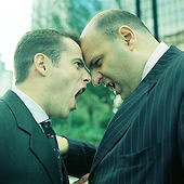 Two men yelling head tp head